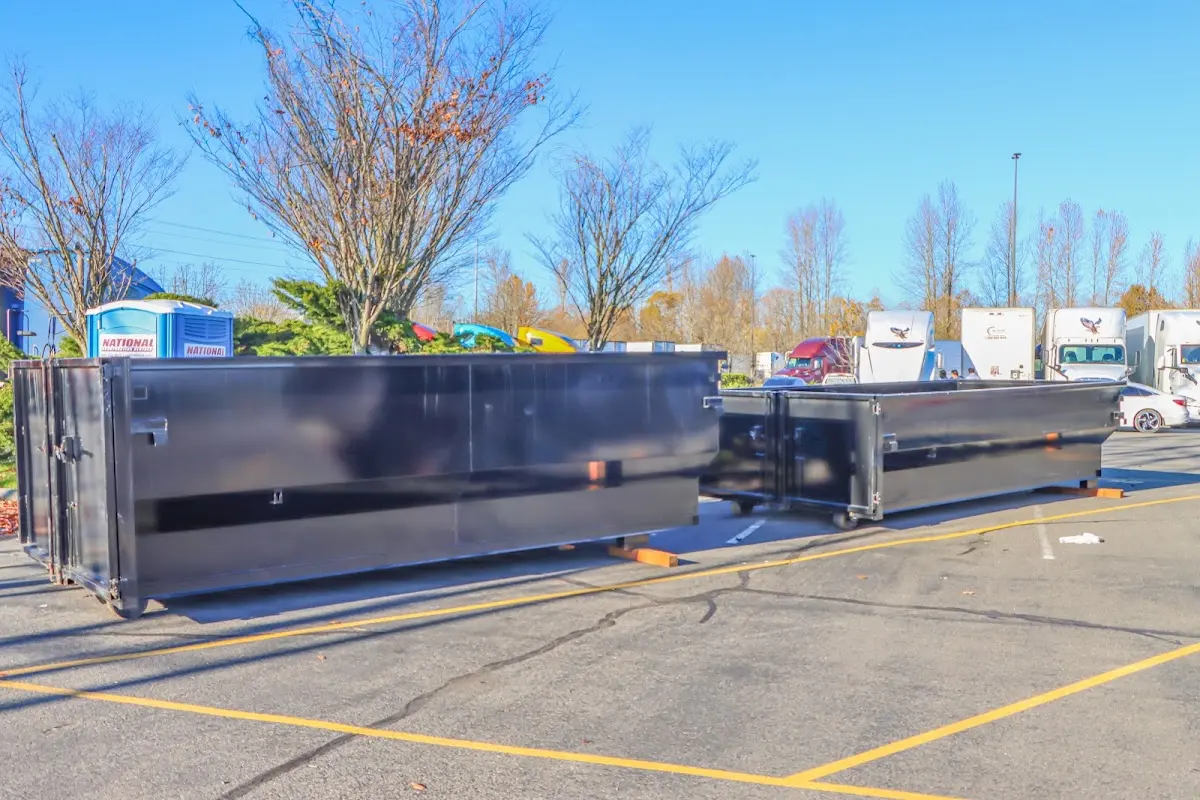 Professional dumpster rental service with roll-off container on residential driveway in Park City